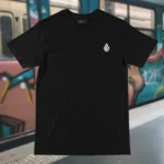 Front view of black tshirt featuring the Moon Fire and night sky over the sea graphic.