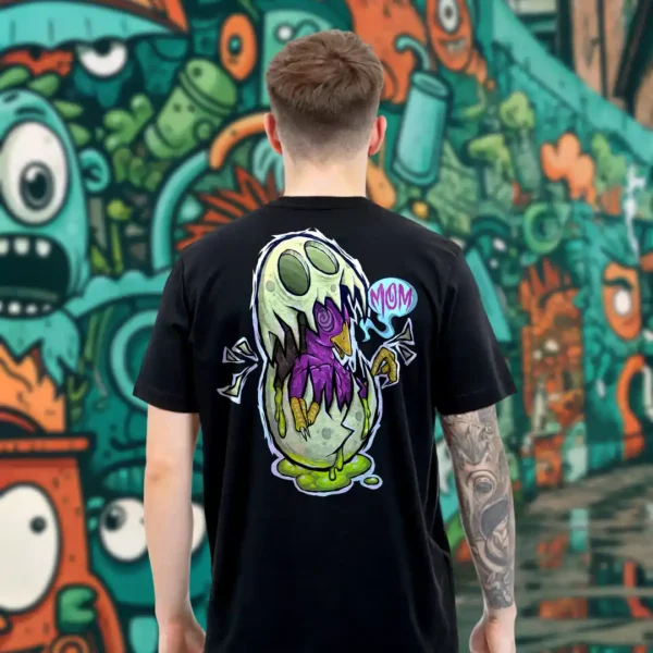 A male model with his back turned wearing a black Easy Days tshirt featuring a monsterfied balut egg graphic.