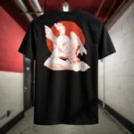 Back view of black Manifesto shirt displaying a giant bald man crawling with its hands and feet as multiple eyes spew from its chest and chin rear graphic placement