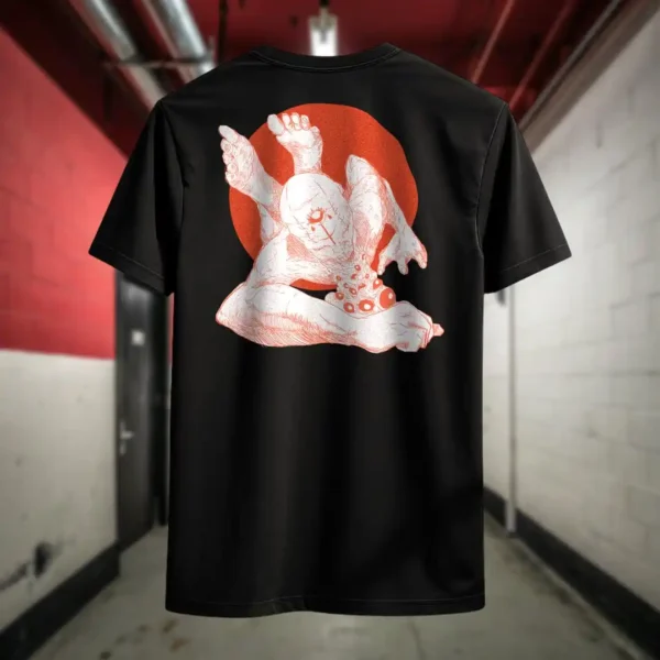 Back view of black Manifesto shirt displaying a giant bald man crawling with its hands and feet as multiple eyes spew from its chest and chin rear graphic placement