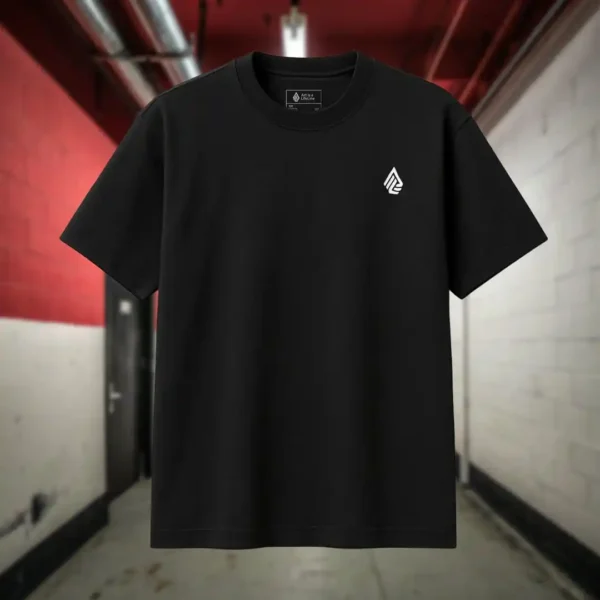 Front view of black shirt featuring a giant bald man crawling with its hands and feet as multiple eyes spew from its chest and chin