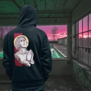 A male model with his back turned wearing a black Manifesto hoodie featuring a man who seems like a statue, hands in a praying position, eyes staring at the skies above