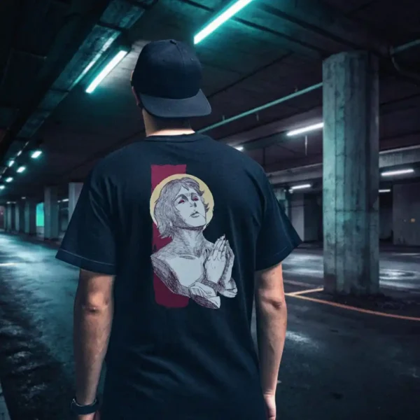 A male model with his back turned wearing a black Manifesto shirt featuring a man who seems like a statue, hands in a praying position, eyes staring at the skies above