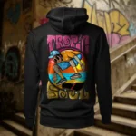 "Back view of black Tropic Soul hoodie displaying the Flip Me skateboard and beach rear graphic placement and hood detail. "