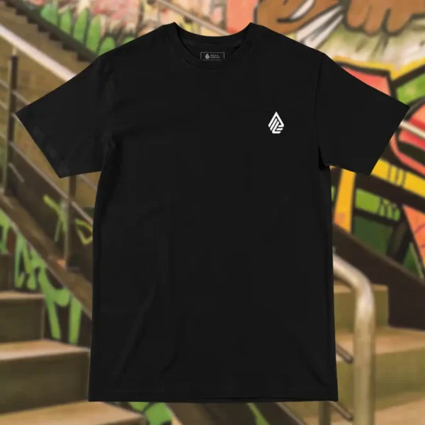 Front view of black tshirt featuring a man relaxing on a hammock tied to the Skull Island's palm trees next to a giant wave graphic.