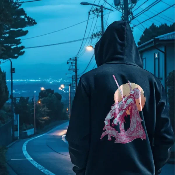 A male model with his back turned wearing a black Manifesto hoodie featuring a man falling back as he's impaled by a spear