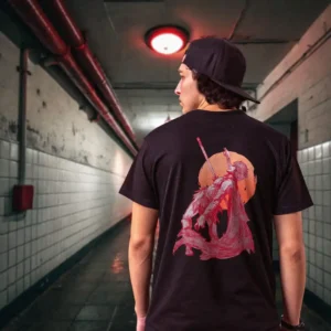 A male model with his back turned wearing a black Manifesto tshirt featuring a man falling back as he's impaled by a spear
