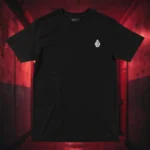 Front view of black t-shirt featuring a warrior with eyes in his wings, a sword piercing through his head.