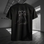 Back view of black Manifesto tshirt displaying a gray winged creature of dark, visibly hanged by ropes, opening its stomach with its unseen face rear graphic placement